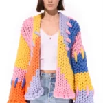 woman wearing colorful chunky knit cardigan and blue jeans minimalist fashion style