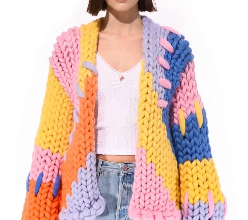 woman wearing colorful chunky knit cardigan and blue jeans minimalist fashion style